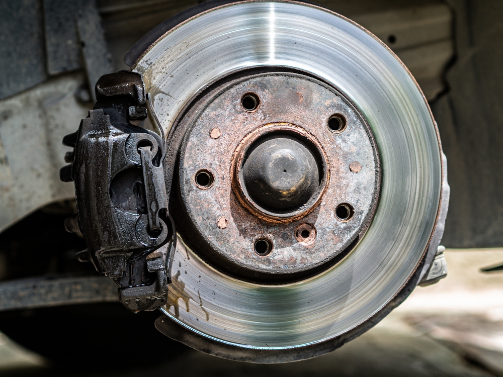 Closeup,Weared,Overheated,Brake,Disk,And,Detail,Of,Wheel,Hub.